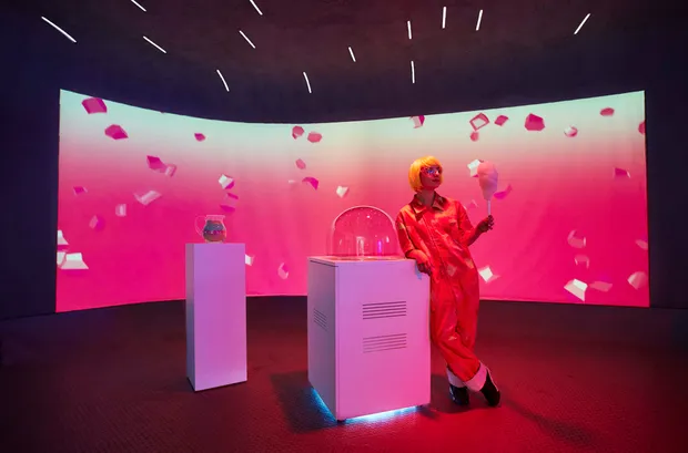 A cotty candy attendant in front of a curved screen at the Red Bull Music Academy