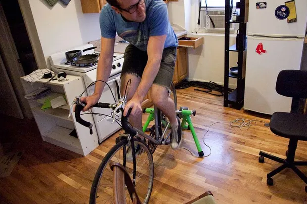 A man testing a bike indoors.