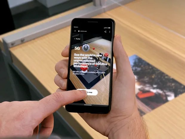 A phoen running a Verizon app with an AR marker in the background.