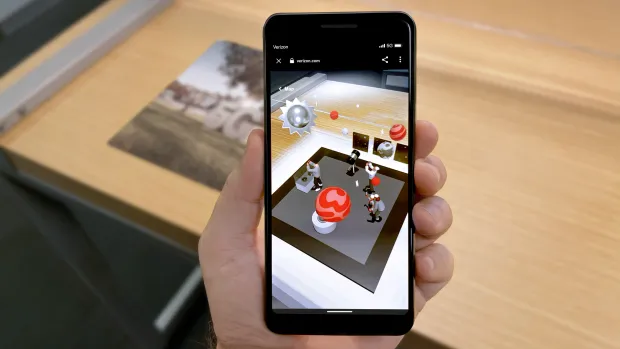 The Verizon AR app showing a planetarium with a table in the background.